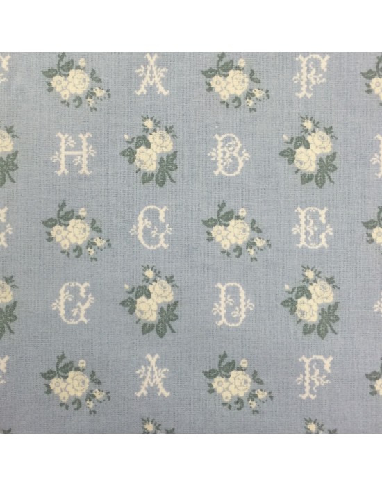 Tela azul con letras y flores blancas Tela azul con letras y flores blancas